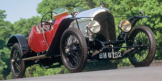 A red Bentley 3-Litre from the 1920s parked on a racing course | Bentley Motors