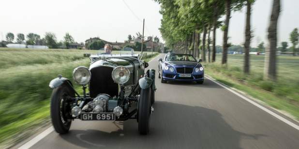 Heritage Bentley Blower driving on a country road in front a convertible | Bentley Motors