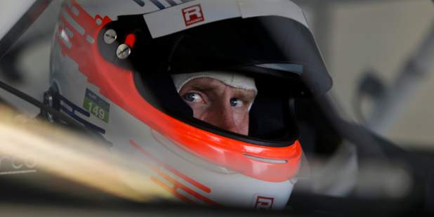 Headshot of Chris Dyson wearing a racing helmet looking toward the camera at Miller Motorsports Park in Utah | Bentley Motors